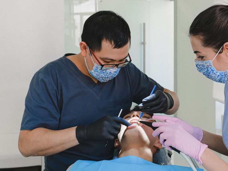 Dental hygienist performing a professional teeth cleaning and exam at Englewood Dentistry