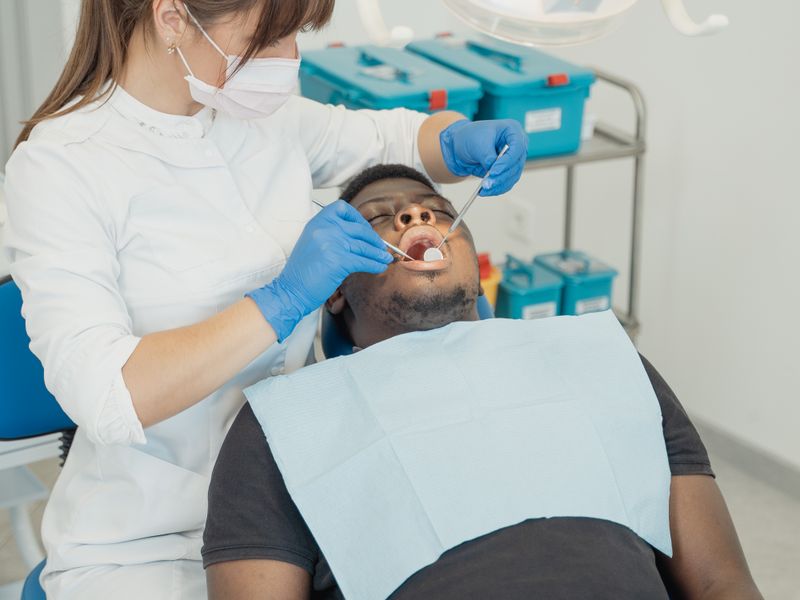 Dentist providing urgent dental care to a patient at Englewood Dentistry