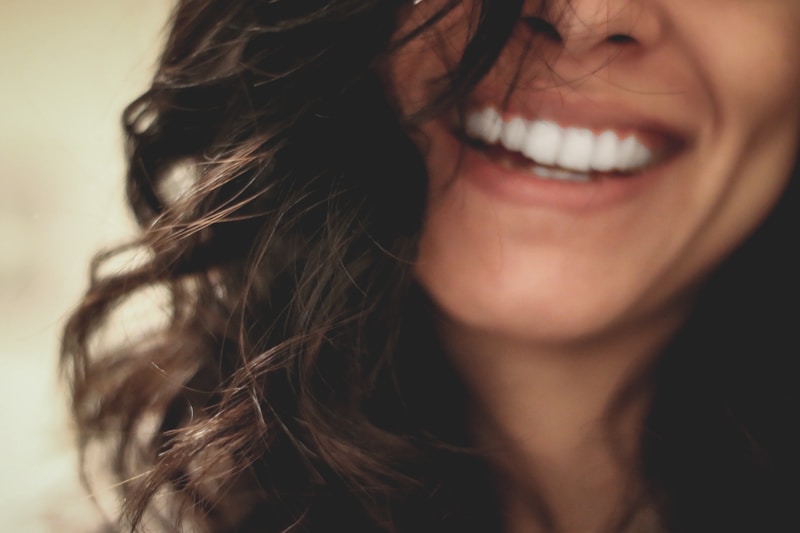 Bright confident smile after cosmetic dental makeover at Englewood Dentistry