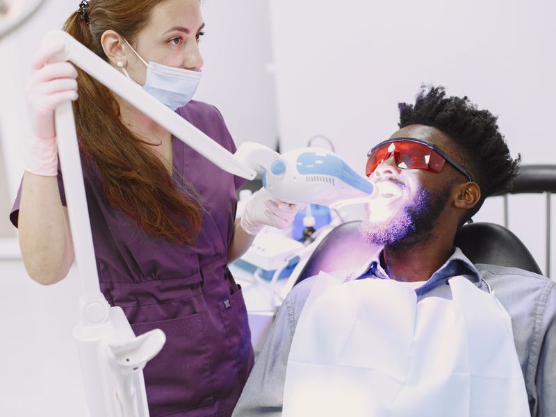 Professional teeth whitening procedure with LED light at Englewood Dentistry