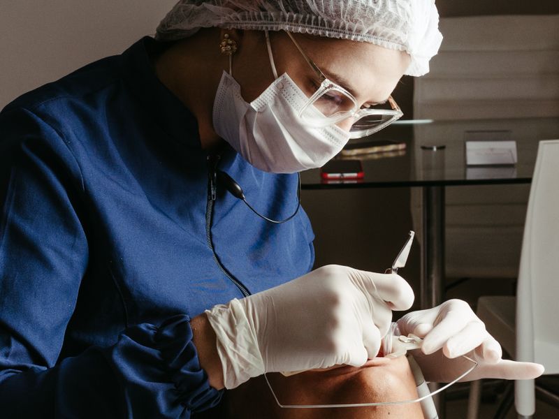 Dentist performing a gentle tooth extraction procedure at Englewood Dentistry